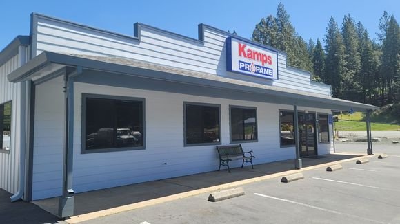 A commercial storefront freshly repainted, a Kamps Propane sign above the entrance