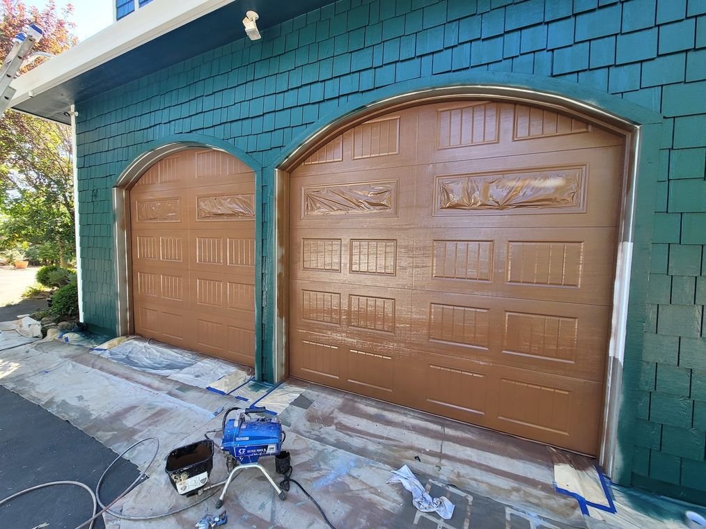 A home exterior masked before painting, windows and garage door covered before the coating goes on