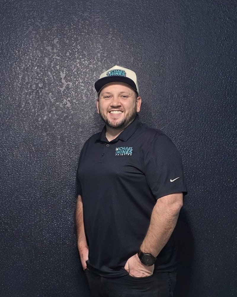 Michael Hines, owner of Michael Hines Painting, in a company shirt and cap