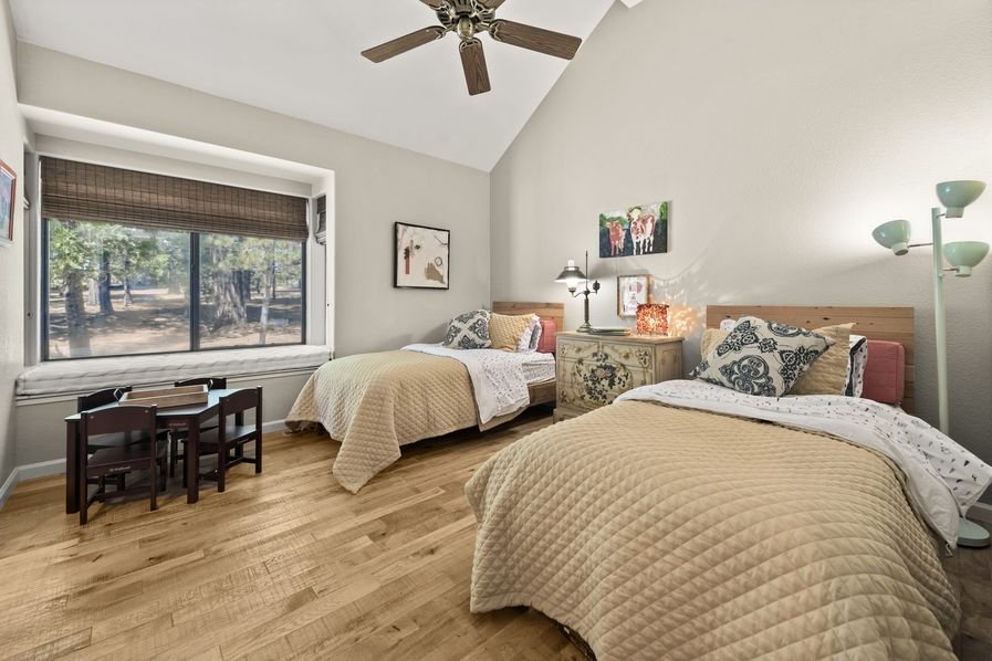 A finished bedroom with freshly painted walls, a vaulted ceiling, and clean corners