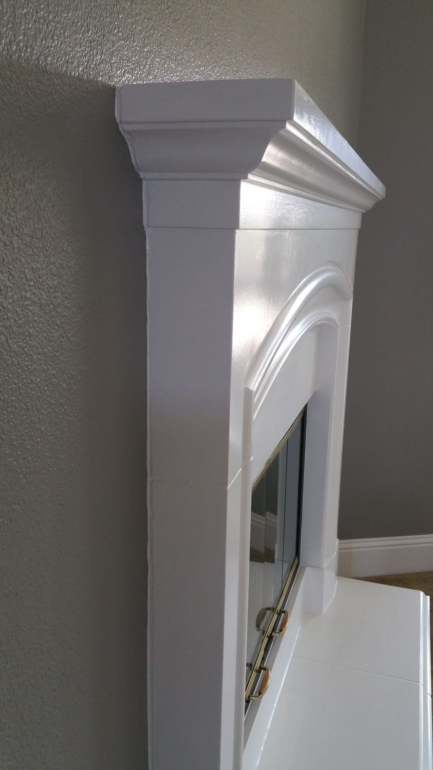 Close-up of crisp painted trim where the wall meets the crown molding, the line cut clean by hand